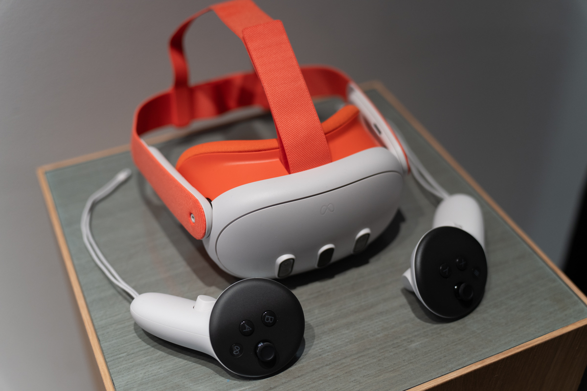 Surface mounted Meta Quest 3 mixed reality headset with orange headband and face pad
