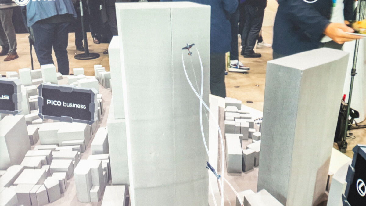 Smartphone view of Shibuya block model with AR planes in front of skyscraper