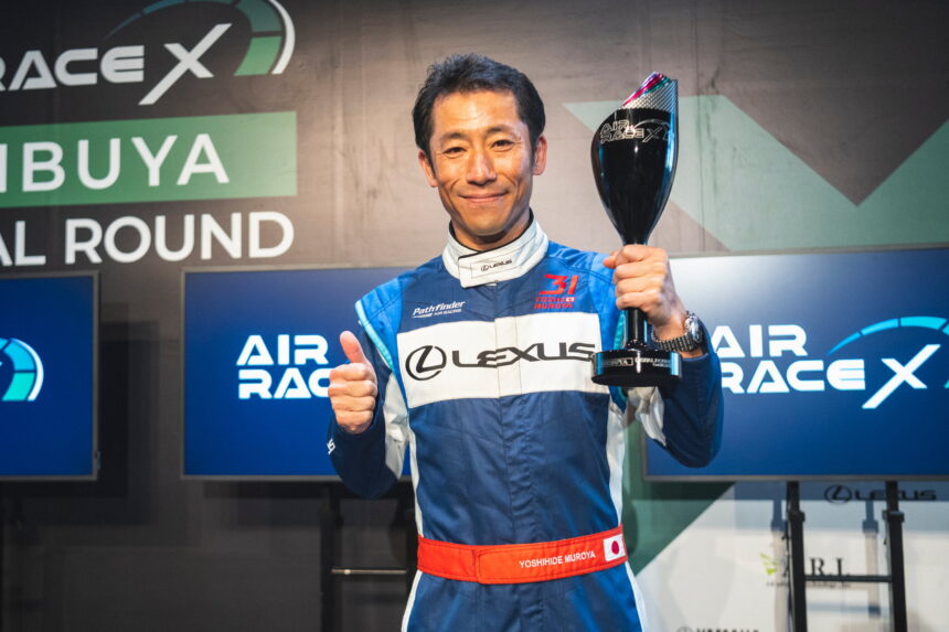 Pilot Yoshi Mori with the award as the winner of the X Air Race