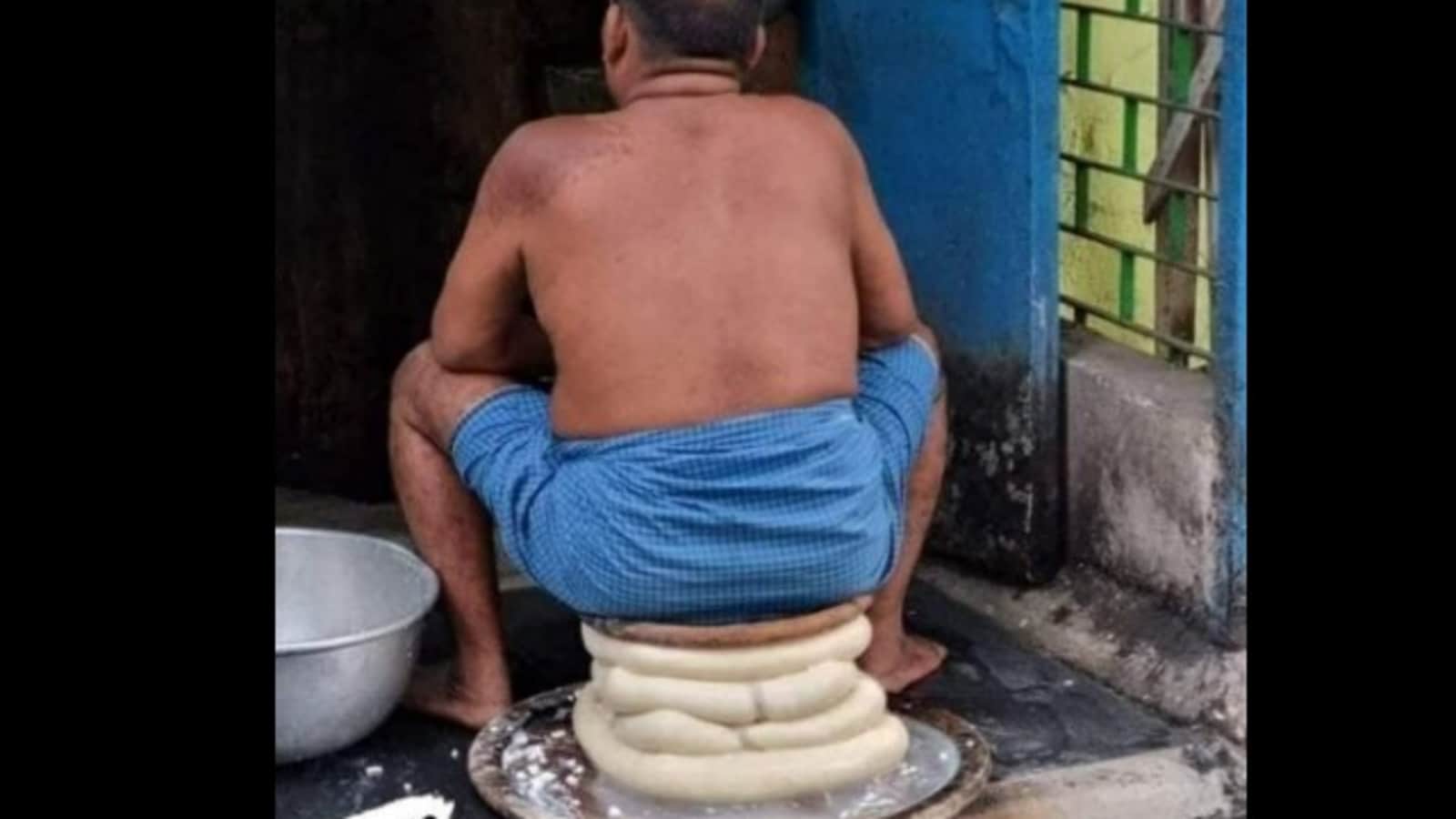 A man sitting on top of a pile of cheese is shocking the internet.  See the photo